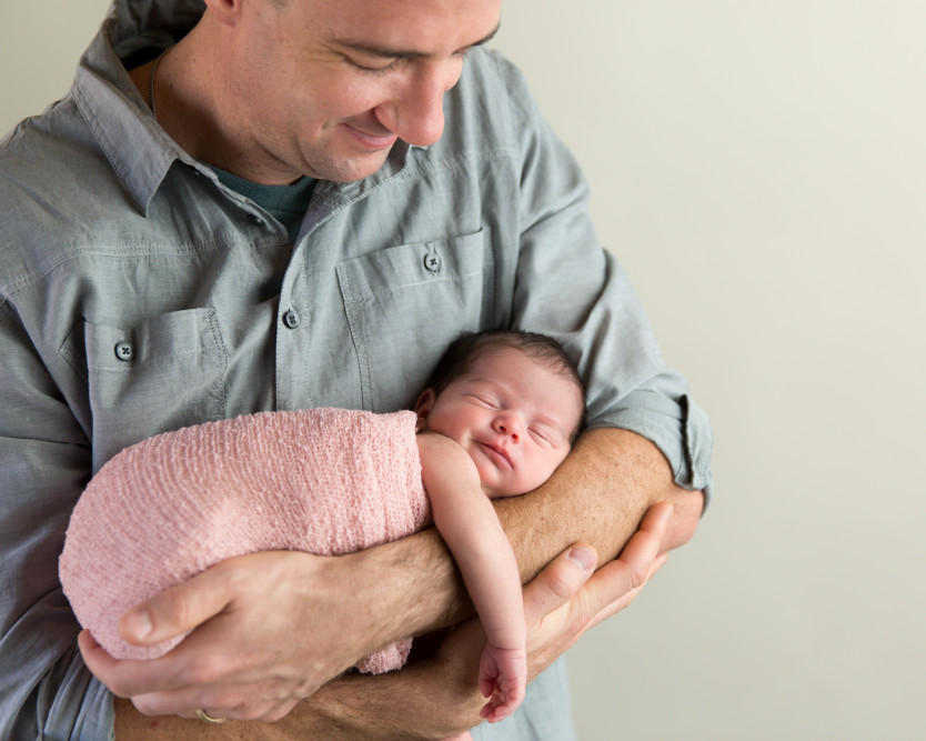 Smiling dad holding baby girl