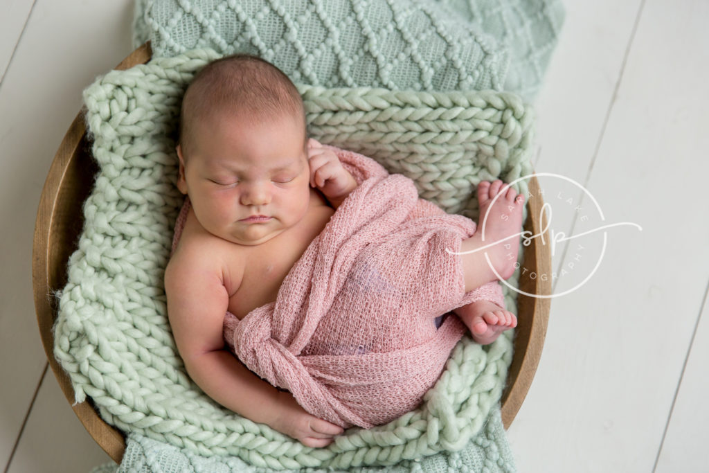 newborn baby in bowl