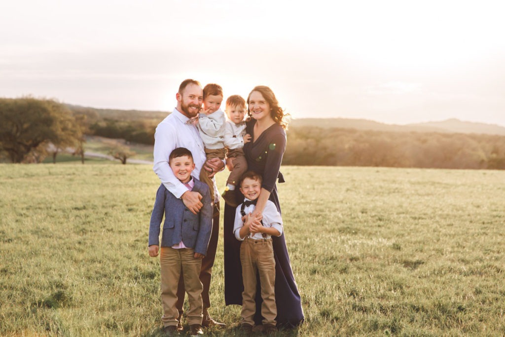 Image of family with four young boys taken at sunset in San Antonio hill country