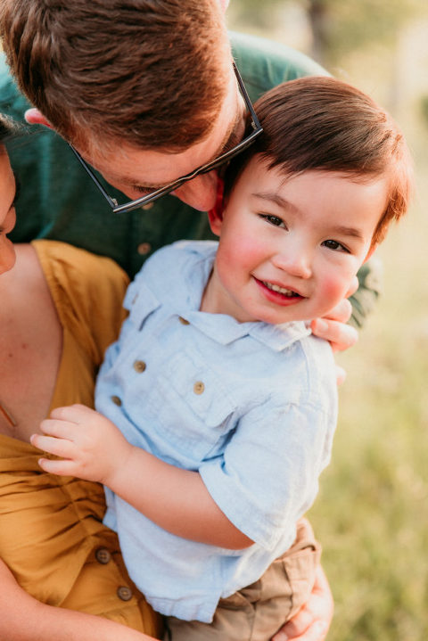 a family snuggling their toddler