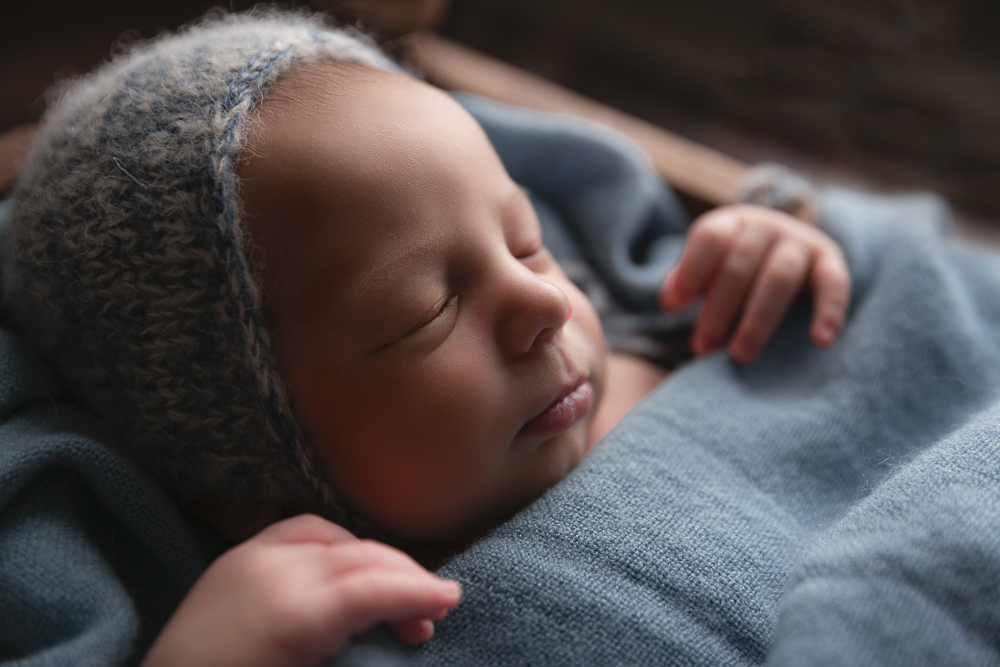 newborn baby boy with blue bonnet