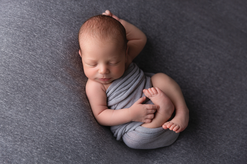 newborn baby sleeping with outstretched arm