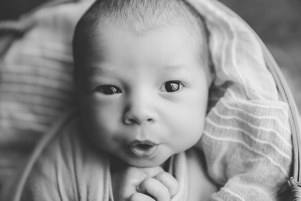 newborn baby pursing his lips