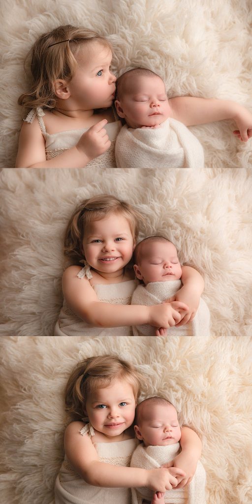 smiling todder girl with her newborn baby sibling