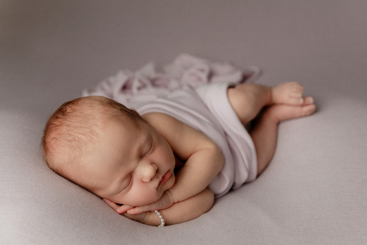 baby girl sleeping on lavender blanket